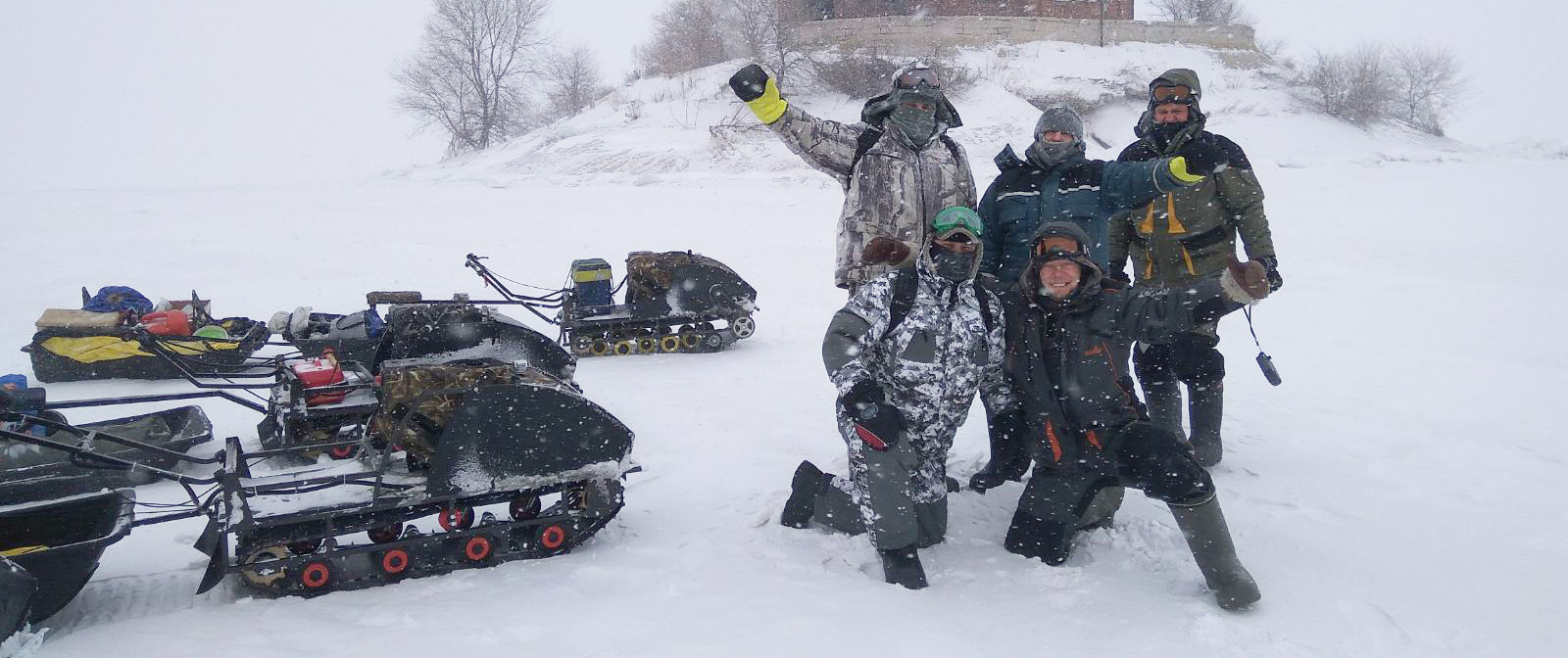 Pchel team posing beside husky machines